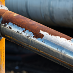 Industrial Corrosion Prevention**

"A close-up shot of a shiny, rust-resistant stainless steel pipe connected to an older, corroded steel pipe. The stainless steel section is pristine, while the corroded section shows clear signs of rust and wear. Focus on the contrast between the two materials. Background should be a blurred industrial setting. safe for work, appropriate content, fully clothed, professional, perfect anatomy, natural proportions, high quality."

**